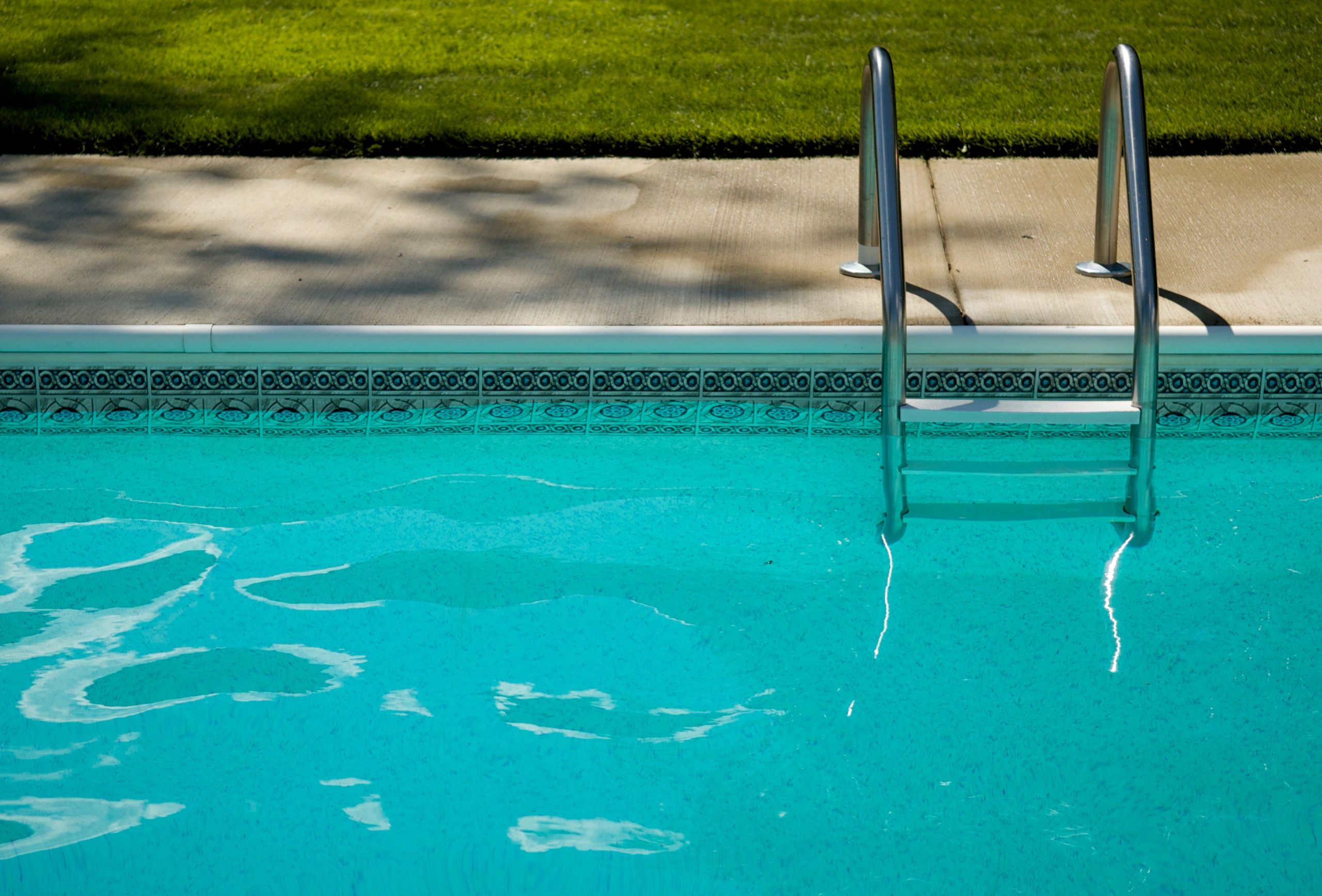 Green algae-filled swimming pool before professional cleanup
